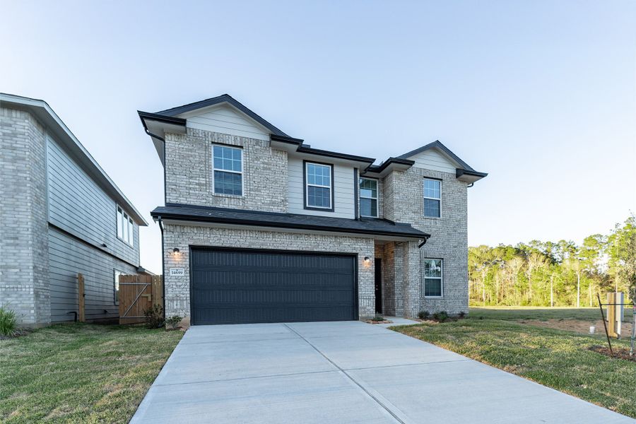 Front exterior of a new home in Caney Mills, Conroe, TX, highlighting curb appeal (Image 25).