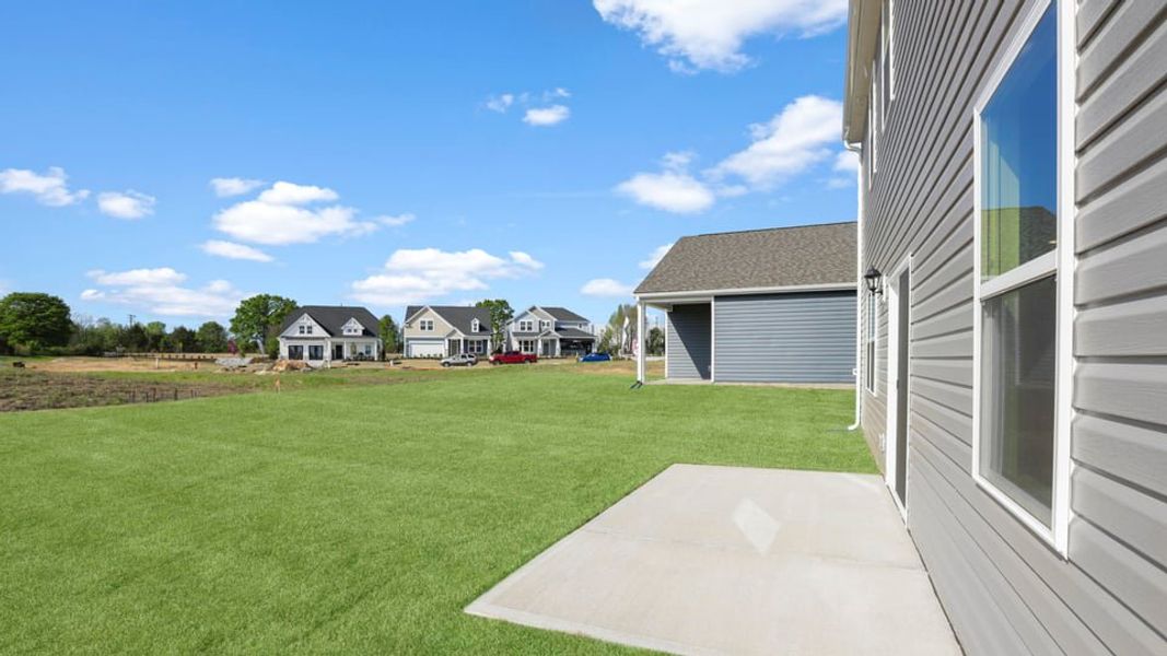 Exterior details and patio area of a home in Durbin Meadows Traditions, Fountain Inn (Image 21).