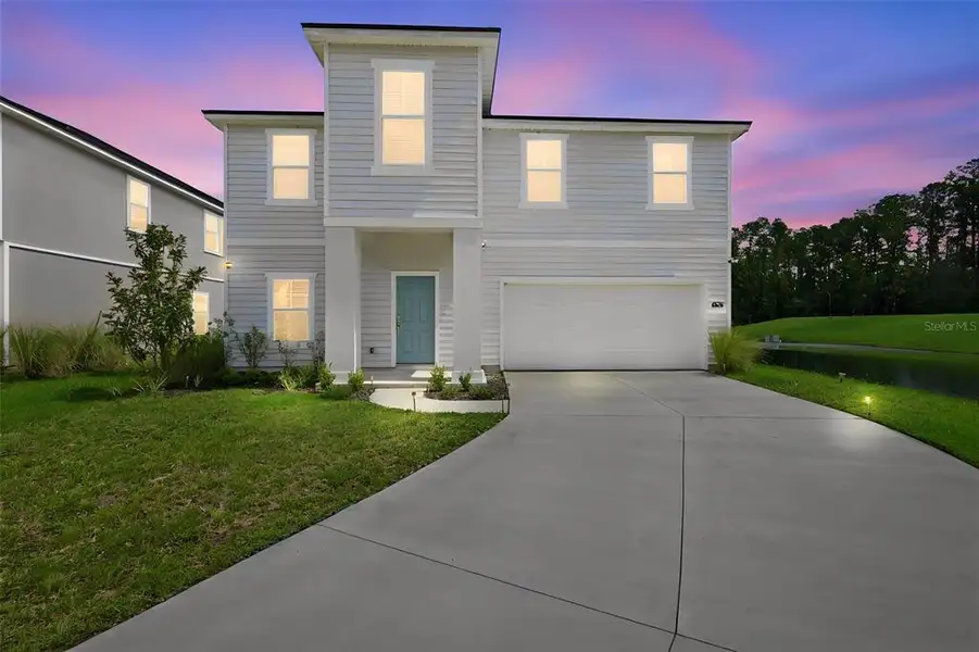 Front exterior of a new home in Dunns Crossing, Jacksonville, FL, highlighting curb appeal (Image 27). Front exterior of a new home in Dunns Crossing, Jacksonville, FL, highlighting curb appeal (Image 27).