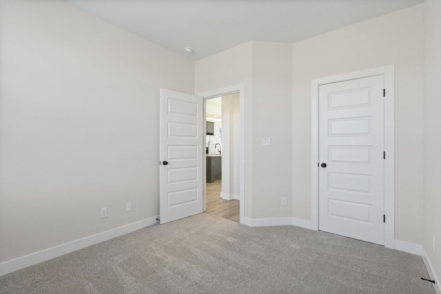 Unfurnished bedroom with light carpet and a closet Unfurnished bedroom with light carpet and a closet