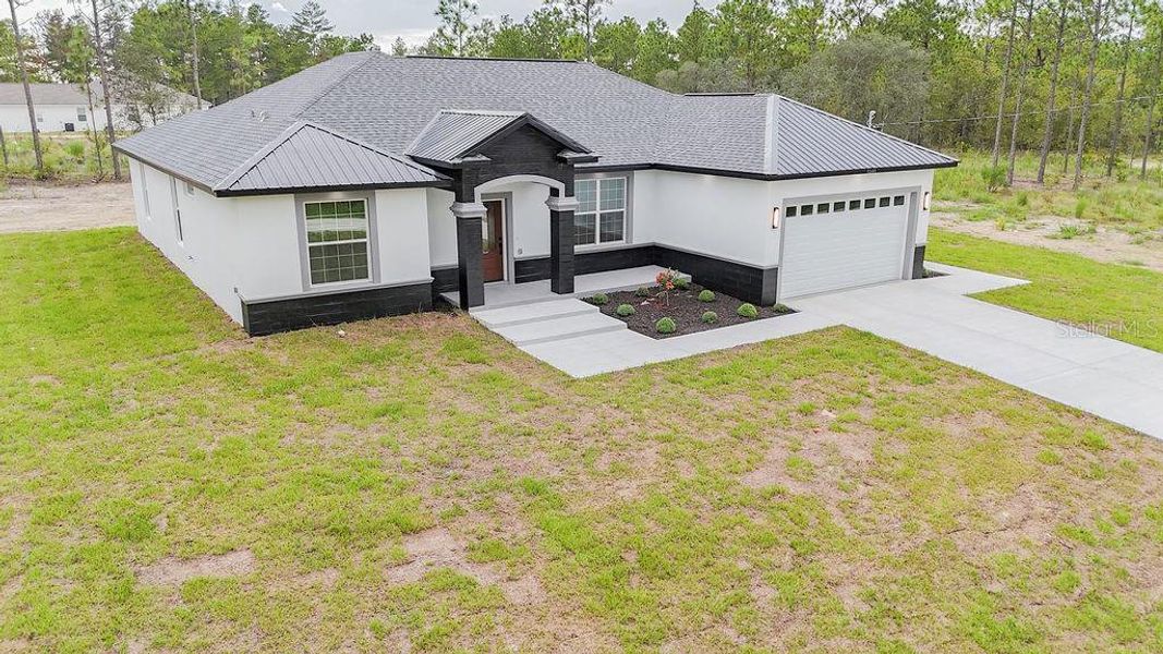Front exterior of a new home in , Dunnellon, FL, highlighting curb appeal (Image 24). Front exterior of a new home in , Dunnellon, FL, highlighting curb appeal (Image 24).