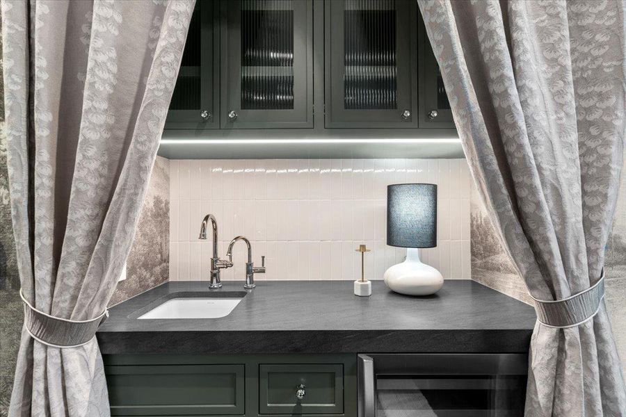 The primary suite coffee bar boasts a Brizo instant hot water faucet & a Samsung 51-bottlewine cooler refrigerator.