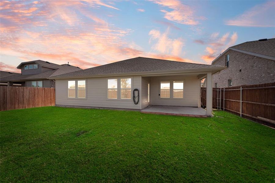 Rear view of property with a patio, a fenced backyard, and a shingled roof Rear view of property with a patio, a fenced backyard, and a shingled roof
