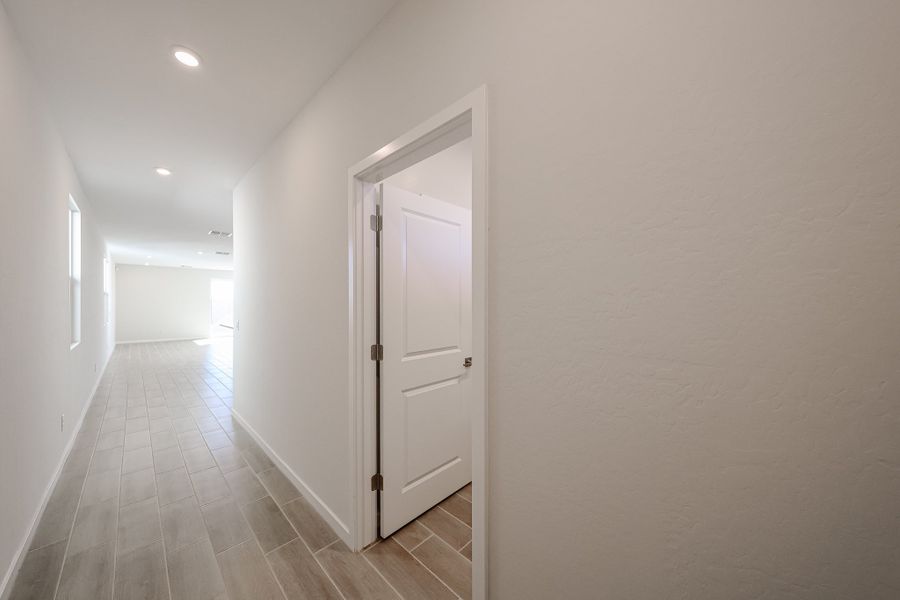 A hallway with white doors. A hallway with white doors.