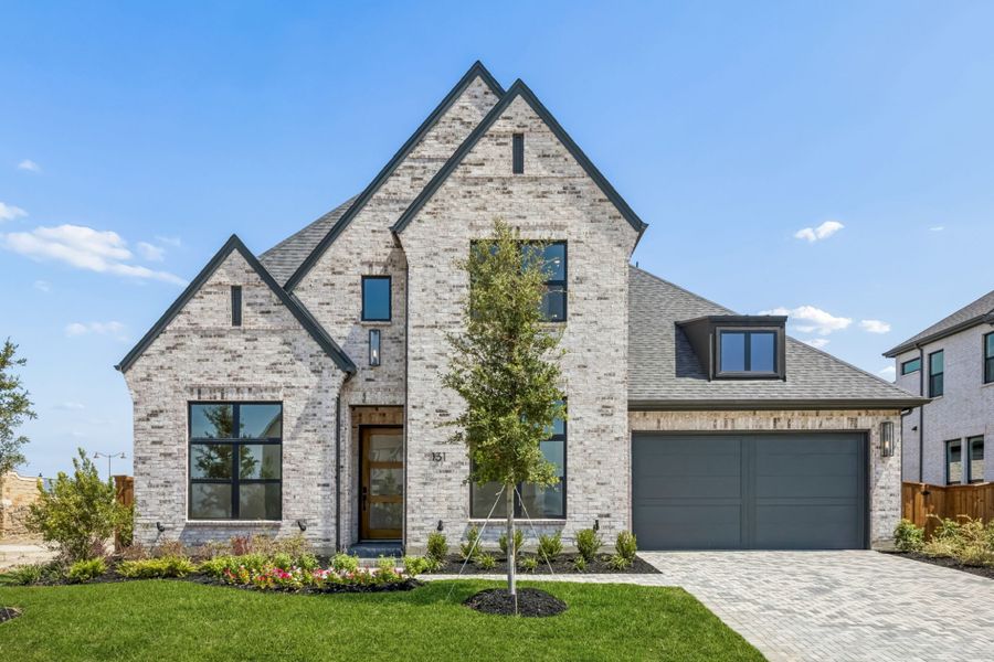 Front exterior of a new home in StarView, Prosper, TX, highlighting curb appeal (Image 1). Front exterior of a new home in StarView, Prosper, TX, highlighting curb appeal (Image 1).