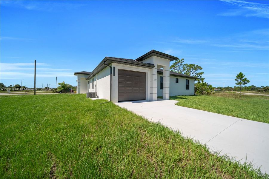 Front exterior of a new home in , Lehigh Acres, FL, highlighting curb appeal (Image 25).