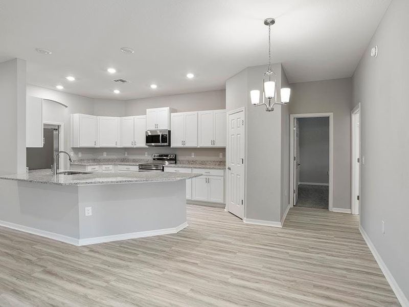 Your spacious kitchen features staggered cabinets, granite countertops, and a walk-in pantry.