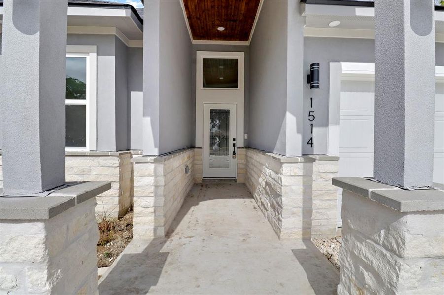 Grand entrance way with custom light fixtures and stone accents.