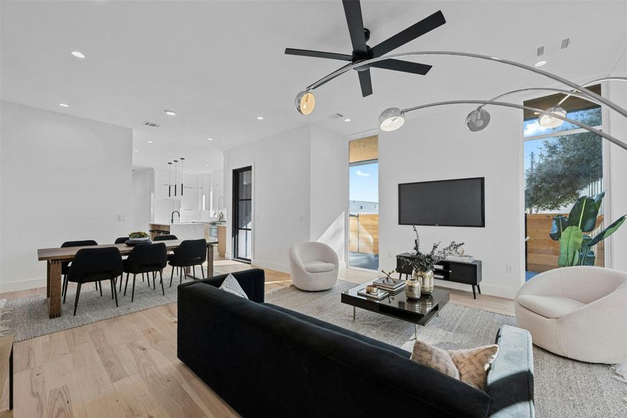 Living area with light wood-style flooring, recessed lighting, and ceiling fan Living area with light wood-style flooring, recessed lighting, and ceiling fan