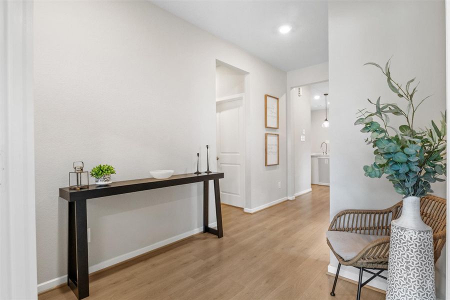 Coming out of the office you see a corridor to the garage and guest space Coming out of the office you see a corridor to the garage and guest space