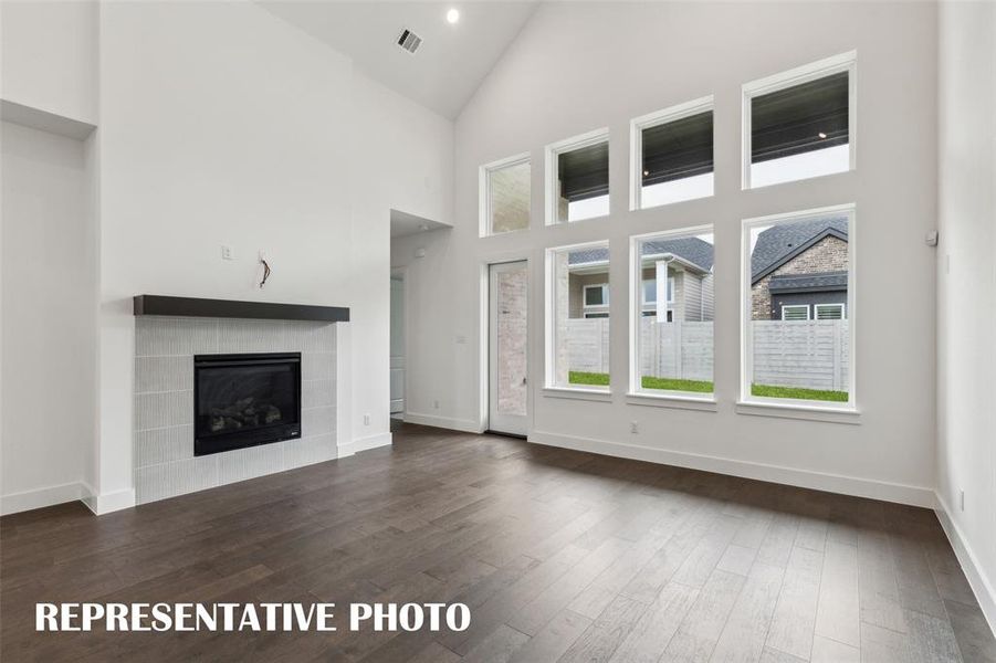 A wall of windows floods this wonderful family room with natural light!  REPRESENTATIVE PHOTO