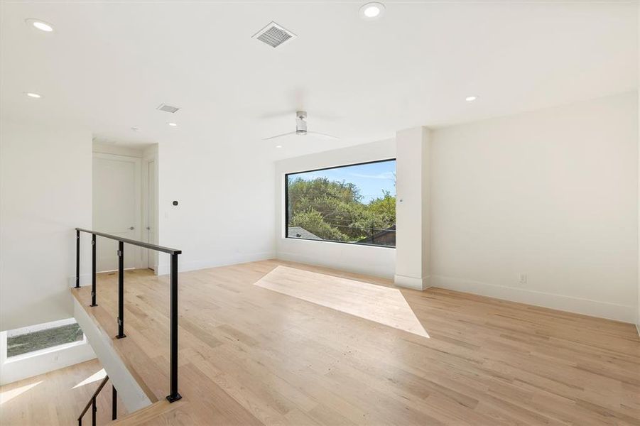 Unfurnished room featuring light hardwood / wood-style floors and ceiling fan