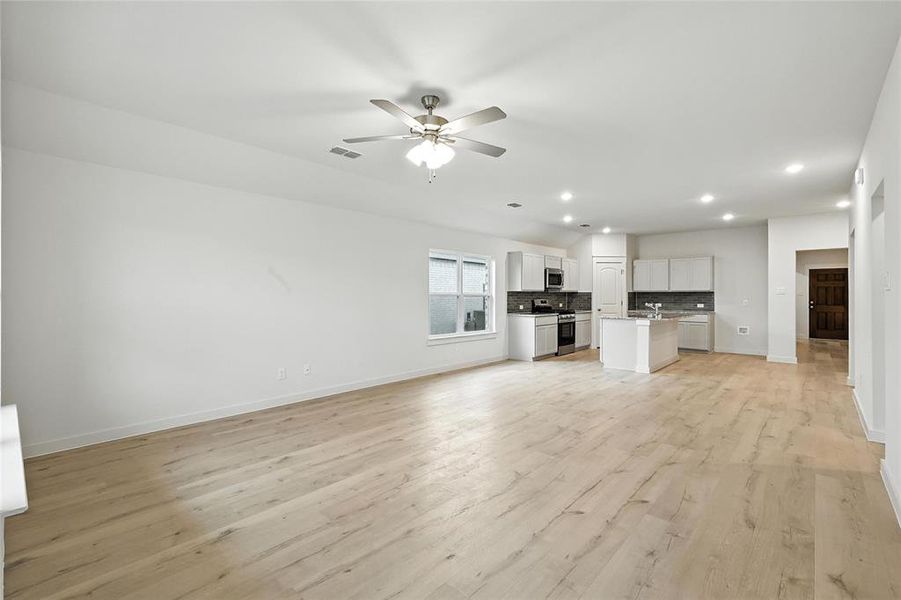 Unfurnished living room with recessed lighting, light wood-type flooring, and ceiling fan