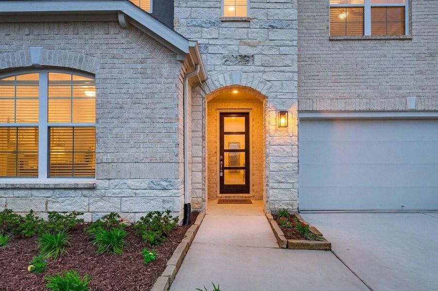 Twilight Photo: Welcome Home! Stunning entrance with a modern 8ft wood door with elegant glass panels.
