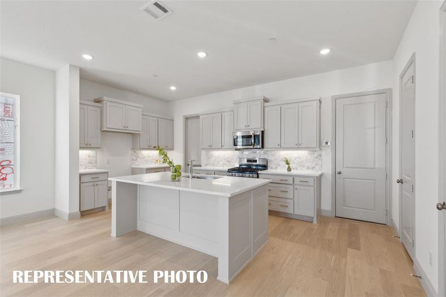 The spacious kitchen island is the perfect gathering place for friends and family.  REPRESENTATIVE PHOTO