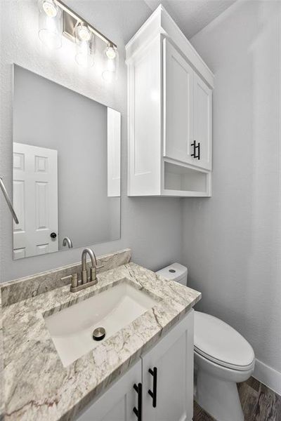 Bathroom with vanity and dark wood-style floors