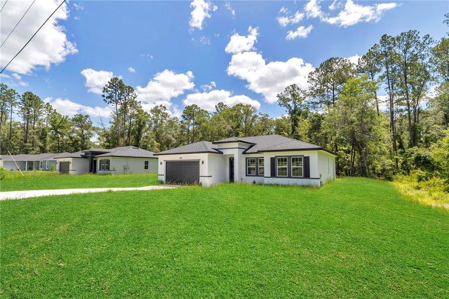 Front exterior of a new home in , Dunnellon, FL, highlighting curb appeal (Image 20).