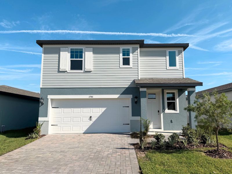 Front exterior of a new home in Two Rivers - Premier Series, Zephyrhills, FL, highlighting curb appeal (Image 1).