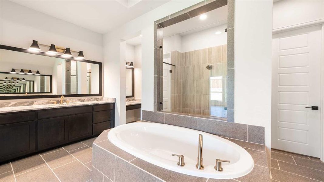 Bathroom featuring separate shower and tub, tile patterned floors, and vanity