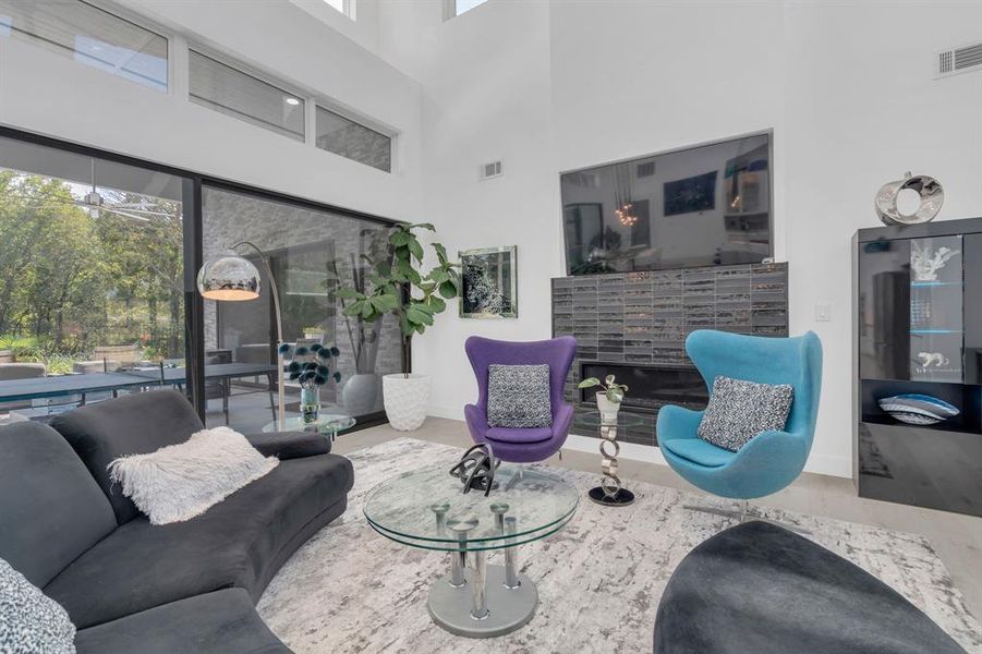 Living area with a towering ceiling and wood finished floors