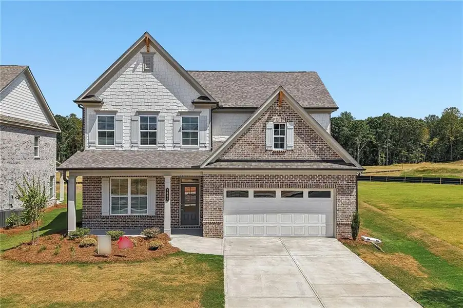 Front exterior of a new home in , Hoschton, GA, highlighting curb appeal (Image 1). Front exterior of a new home in , Hoschton, GA, highlighting curb appeal (Image 1).