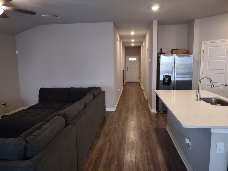 Living room featuring dark wood-style floors, a ceiling fan, and recessed lighting