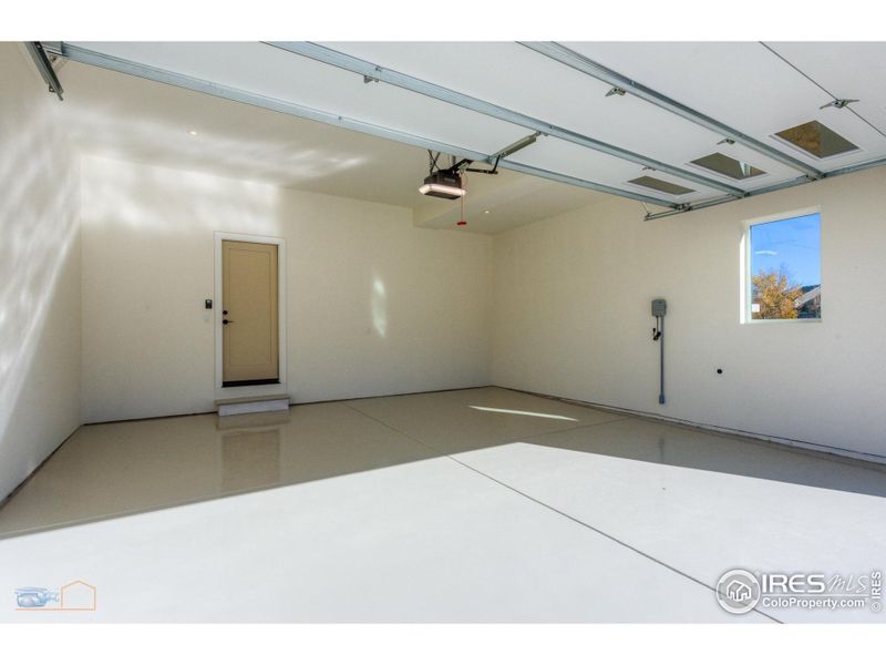 Oversized 2 Car Garage Is Insulated, Finished & Painted. It Also Has An Electric Car Charger & An Epoxy Floor Finish