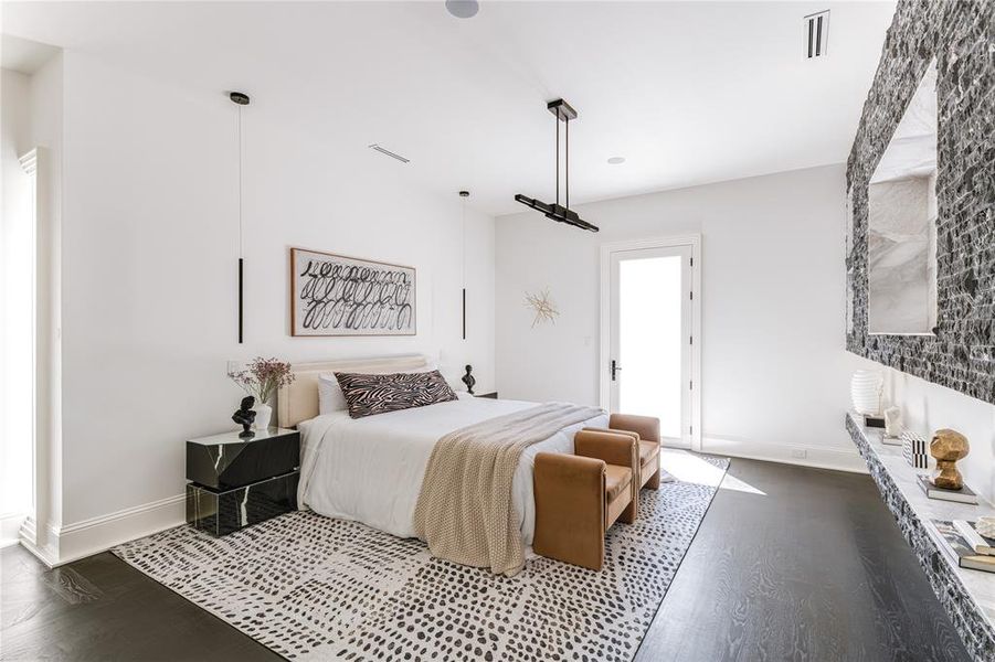 Bedroom featuring baseboards, visible vents, and wood finished floors