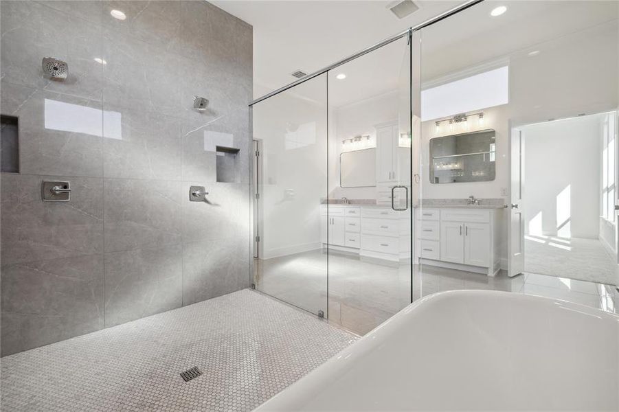 Bathroom featuring independent shower and bath and vanity