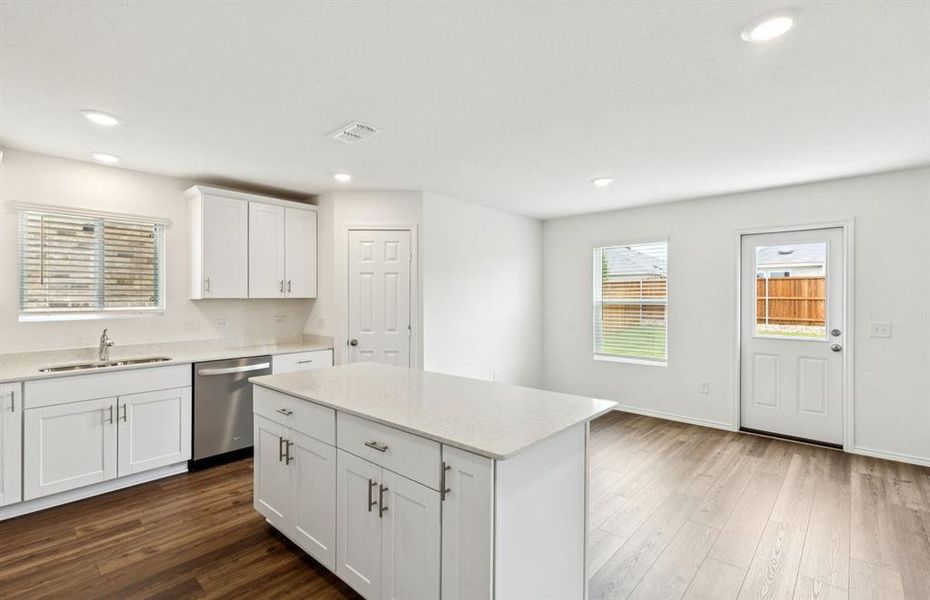 Large island overlooking gathering room and dining areas Large island overlooking gathering room and dining areas