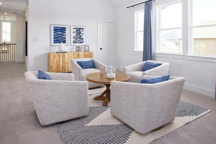 Sitting room with carpet and lofted ceiling