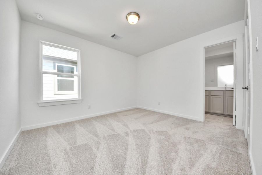 Generously sized secondary bedrooms featuring spacious closets, soft and inviting carpeting underfoot, large windows allowing plenty of natural light, and the added touch of privacy blinds for your personal retreat. Sample photo of completed home with similar floor plan. Actual colors and selections may vary.
