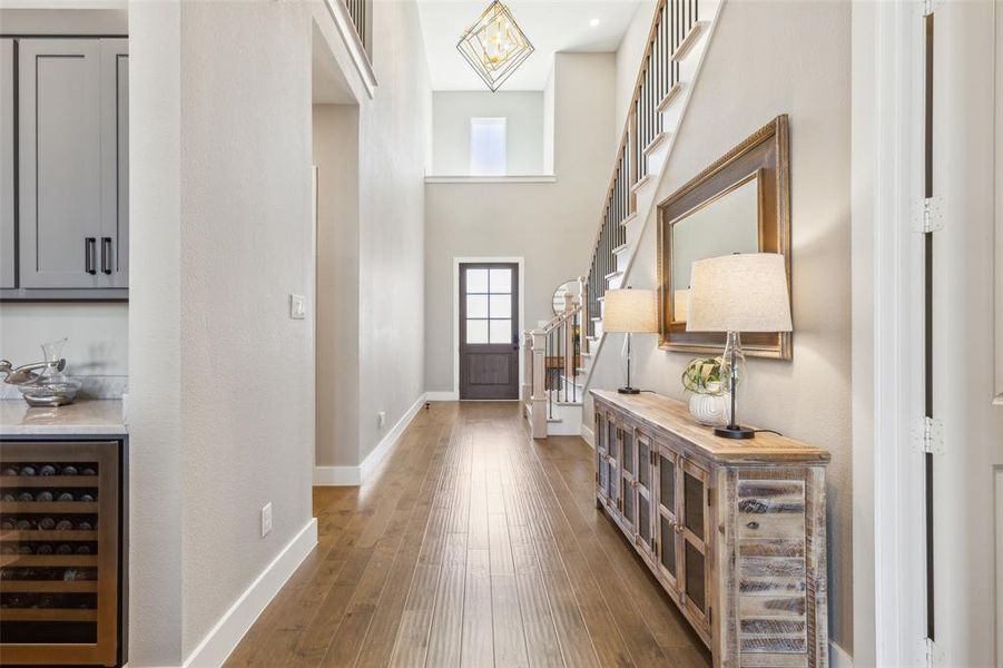 Foyer with hardwood / wood-style floors and beverage cooler