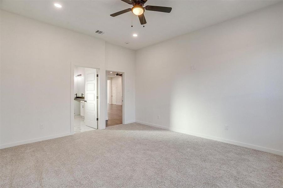 Unfurnished room featuring ceiling fan and light colored carpet