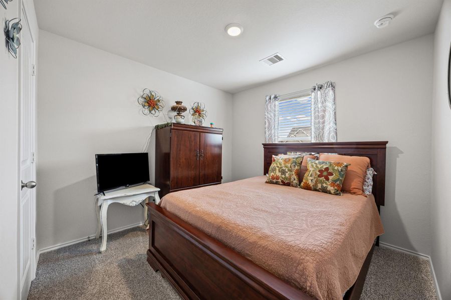 Bedroom featuring dark colored carpet and baseboards