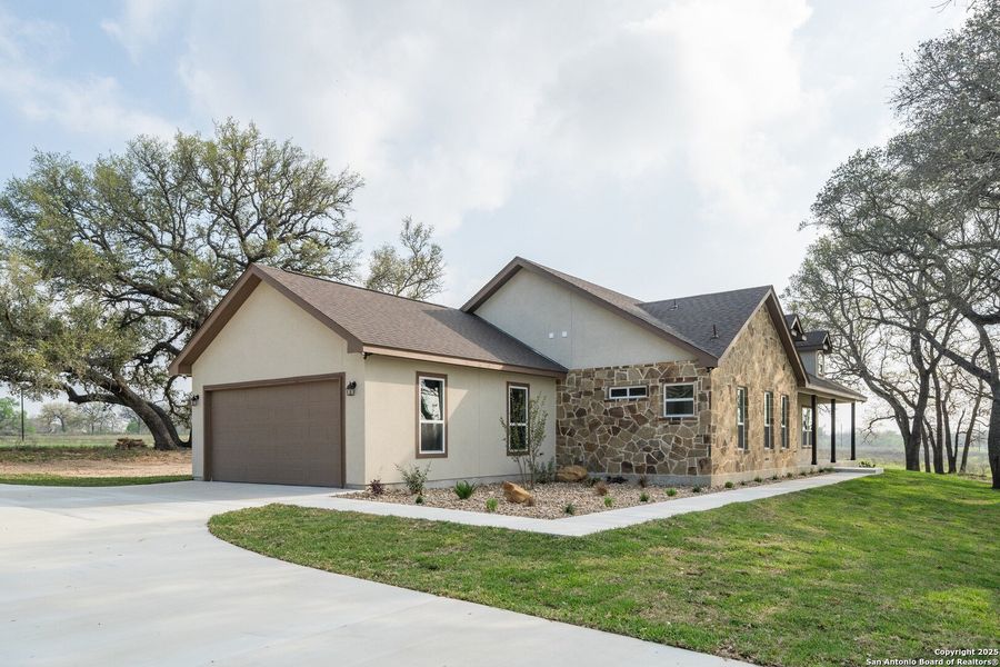Front exterior of a new home in , Floresville, TX, highlighting curb appeal (Image 1). Front exterior of a new home in , Floresville, TX, highlighting curb appeal (Image 1).