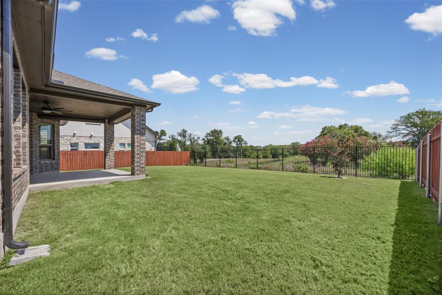 A spacious, well-maintained yard provides ample room for outdoor activities and relaxation.