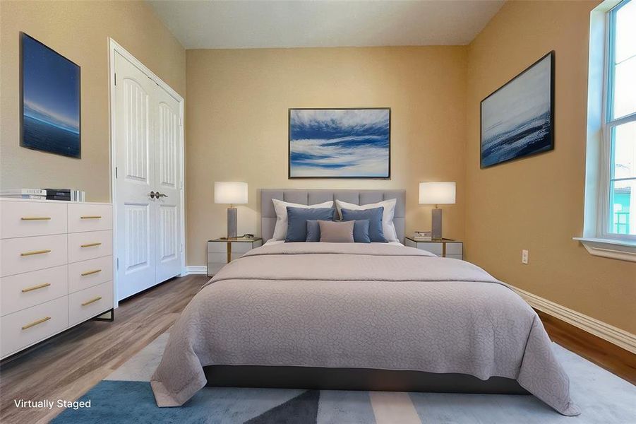 Bedroom featuring baseboards and wood finished floors