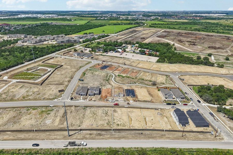 New home construction progress spans this developing residential neighborhood in an aerial view.