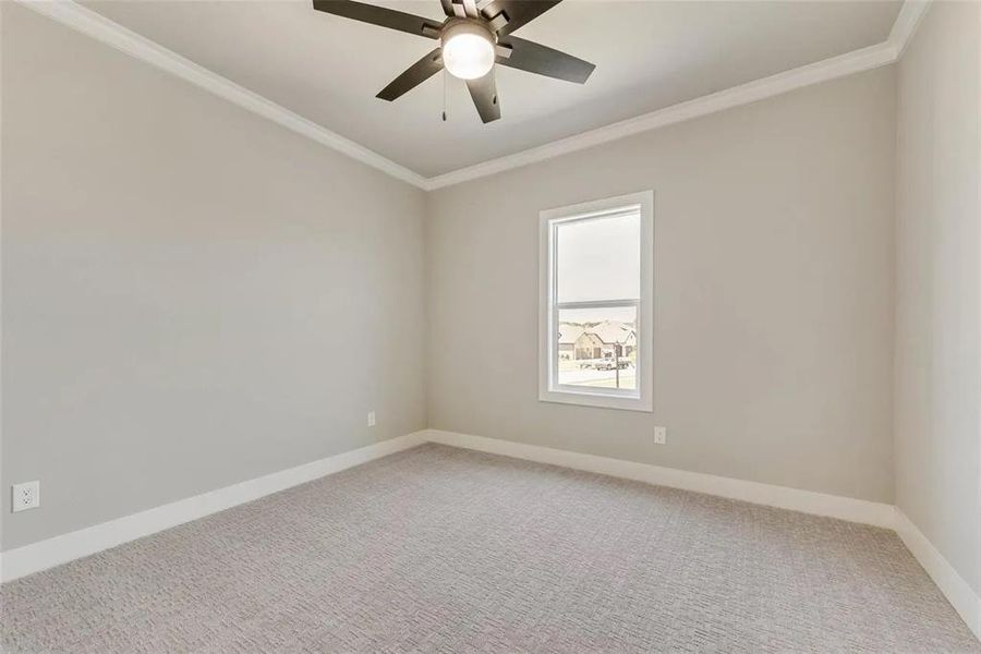 Unfurnished room featuring ornamental molding, light carpet, and ceiling fan