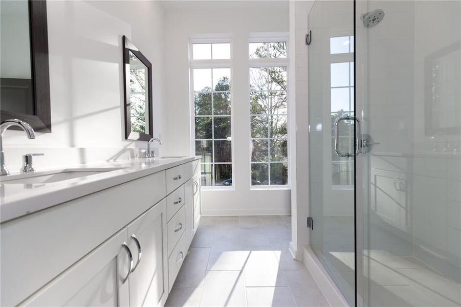 Owners bathroom features quartz countertops and upgraded walk in shower tiles *Home is Under Construction. Photos shown are from other TPG Communities to display how the home will live*