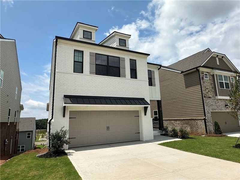 Front exterior of a new home in Kentmere, Auburn, GA, highlighting curb appeal (Image 1). Front exterior of a new home in Kentmere, Auburn, GA, highlighting curb appeal (Image 1).
