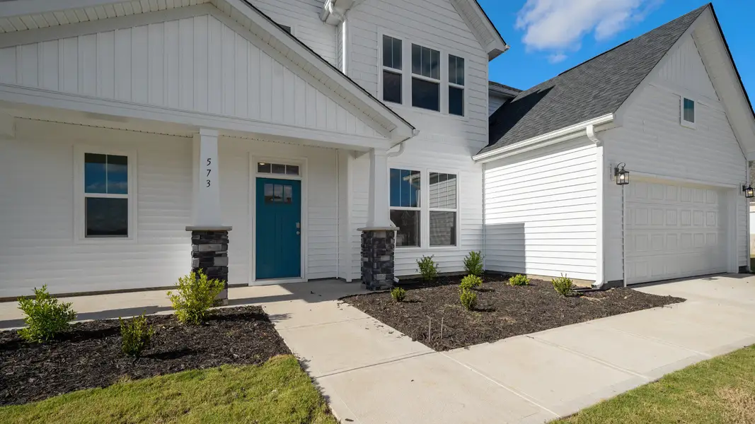 2 story single family home, all white with a 2 car garage