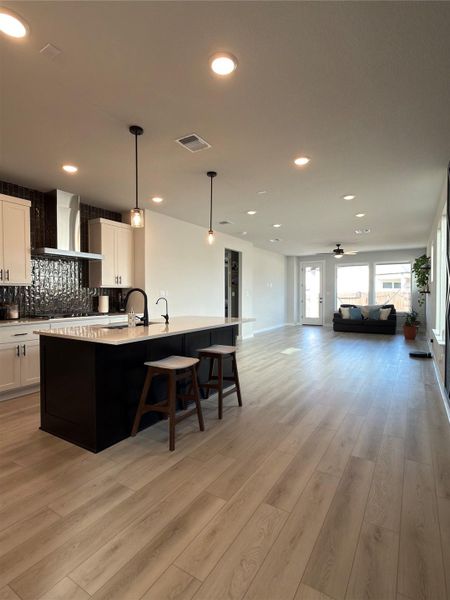 Open-concept living space with wood-finish flooring throughout