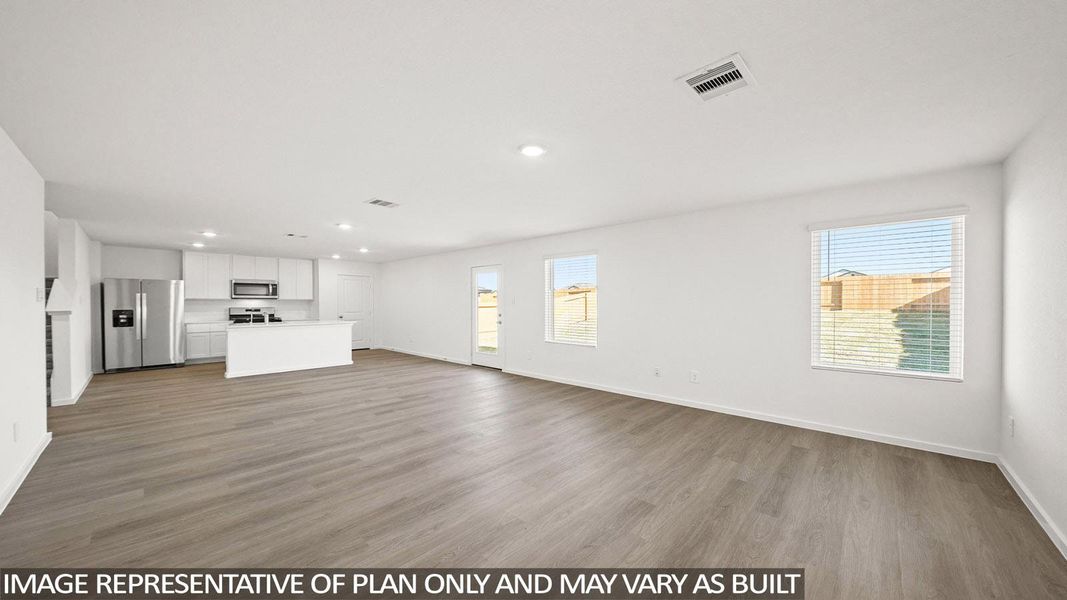 An open-concept interior offers seamless flow between living, dining, and kitchen areas.