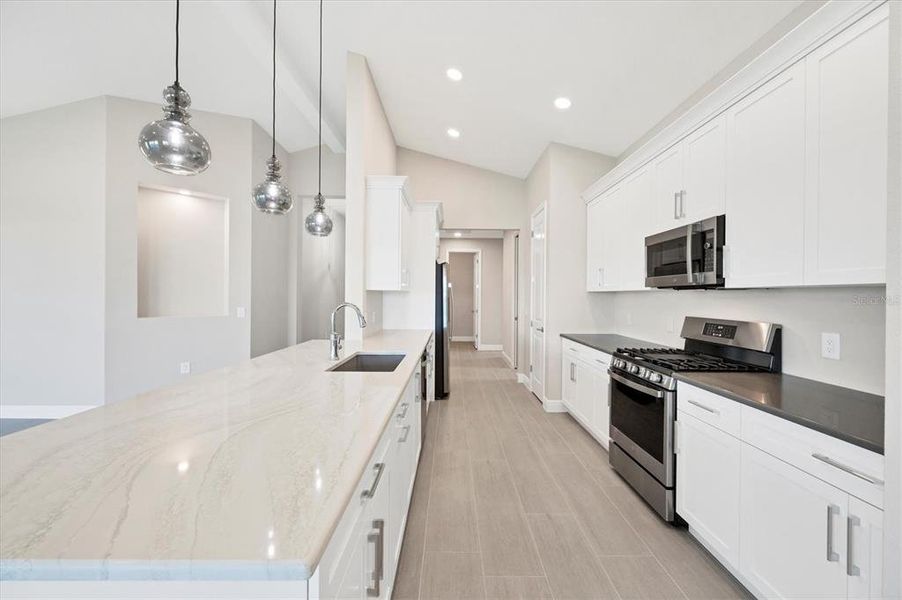 Kitchen, wood cabinetry, Vaulted ceiling, gas range