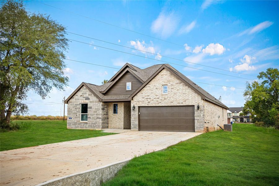 Front exterior of a new home in , Prairie View, TX, highlighting curb appeal (Image 14).