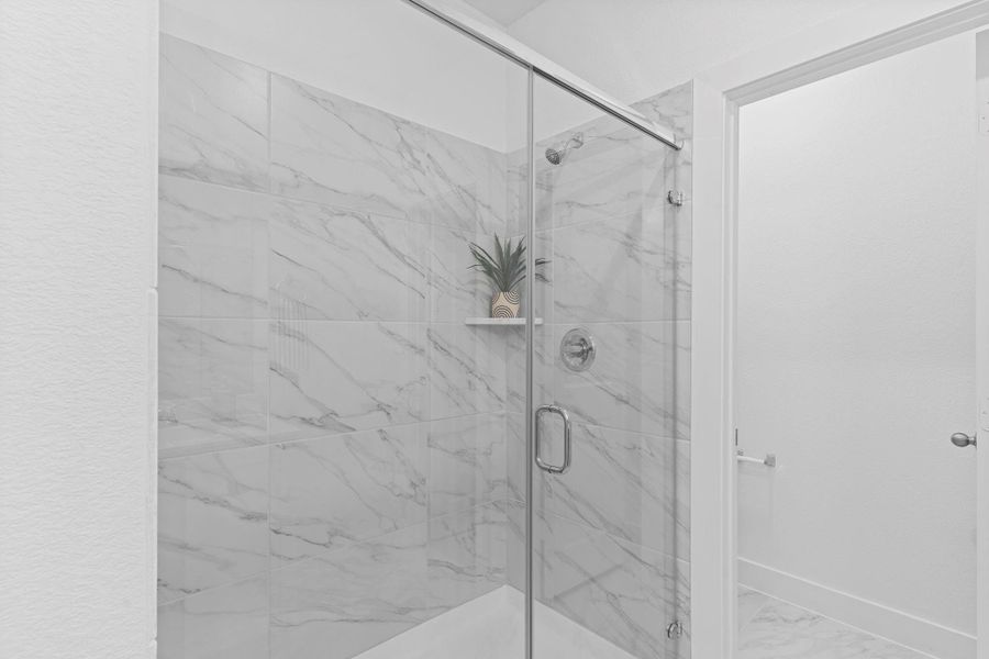 Enjoy the luxury of a walk-in super shower surrounded by elegant tile and glass—bringing a spa-like feel right into your own home.