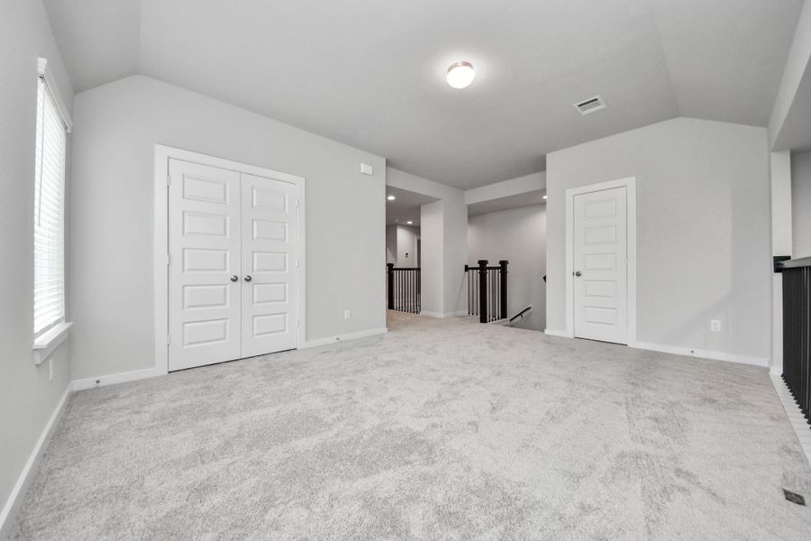 Generously sized secondary bedrooms featuring spacious closets, soft and inviting carpeting underfoot, large windows allowing plenty of natural light, and the added touch of privacy blinds for your personal retreat. Sample photo of completed home with similar floor plan. Actual colors and selections may vary.