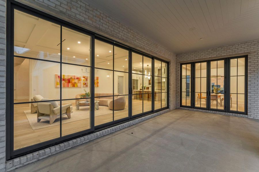 Expansive panoramic pocket glass doors create a seamless transition from the outdoors to the Great Room, perfect for entertaining Expansive panoramic pocket glass doors create a seamless transition from the outdoors to the Great Room, perfect for entertaining